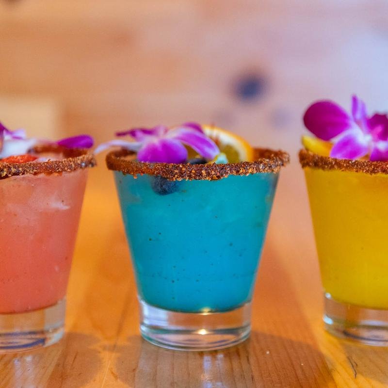 Fresh margaritas beside chips and salsa.